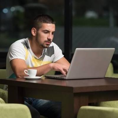 Man on laptop in the Take 5